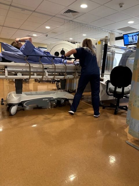 Tech rolling me into the tube. She's got all the muscles.